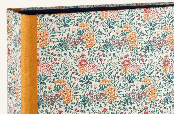 folder with scattered flowers, spine reinforced with orange linen edges